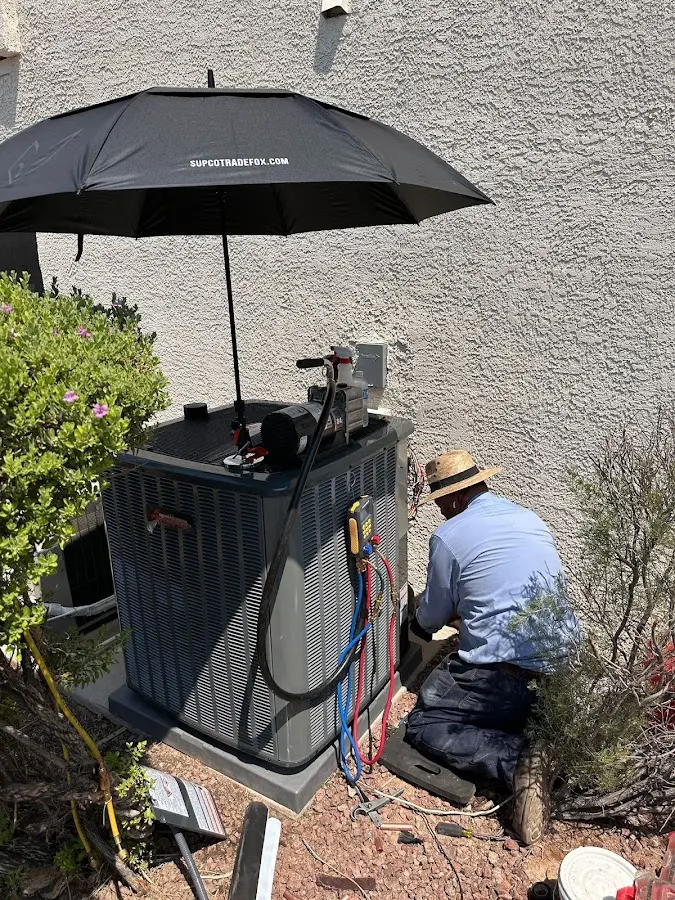 HVAC technician performing outdoor AC maintenance in Belmar